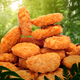 Stack of plant-based "chicken" nuggets with a green forest background